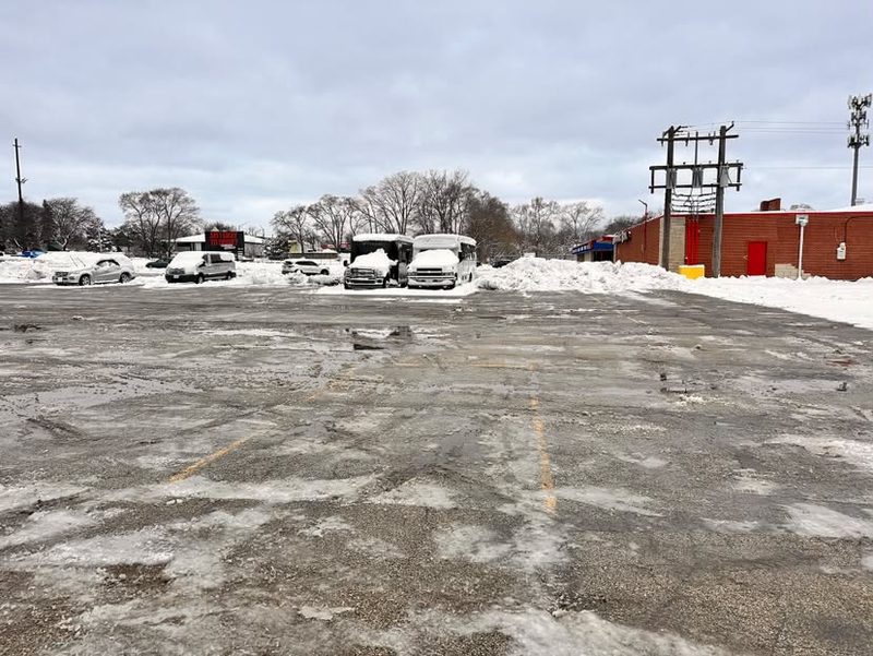 Cleared lot with snow piled clear of the parking bays.
