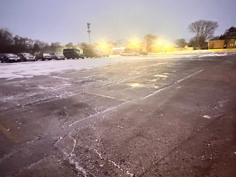 A cleared lot under the lights before daylight.