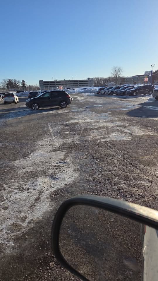 A cleared lot in daylight, seen from the plow truck.